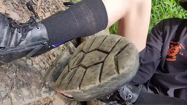 emo t-girl plays in the dirt with her boots and feets